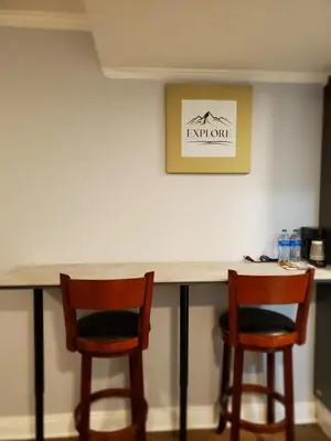 two chairs sitting at a bar in a room at Hotel Europa in Smeltzer