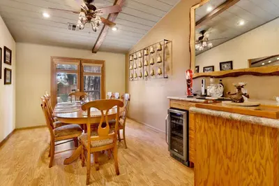 a kitchen and dining room with a table and chairs at Moose Manor #2012 by Big Bear Vacations in Big Bear Lake
