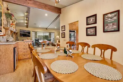 a dining room with a wooden table and chairs at Moose Manor #2012 by Big Bear Vacations in Big Bear Lake