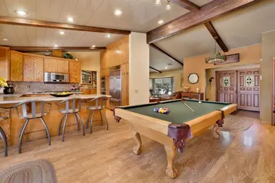 a pool table in a room with a kitchen at Moose Manor #2012 by Big Bear Vacations in Big Bear Lake