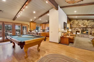 a pool table in a living room with a fireplace at Moose Manor #2012 by Big Bear Vacations in Big Bear Lake