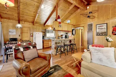 a living room with a couch and a kitchen at Marin Getaway #2013 by Big Bear Vacations in Big Bear Lake