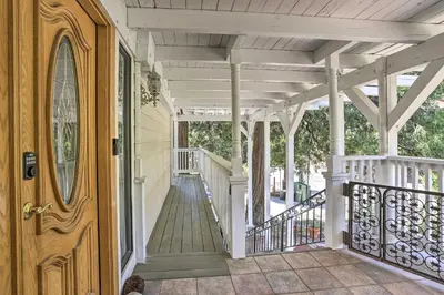 a front porch of a house with a wooden door at Boho-Chic Home with Game Room Near Lake Gregory! in Crestline