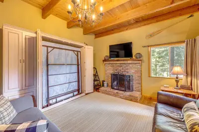 a living room with a couch and a fireplace at Game Room and 2 Decks Walkable Lake Arrowhead Cabin in Lake Arrowhead