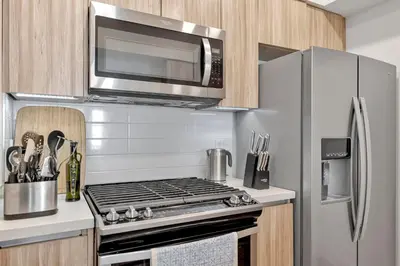 a kitchen with a stainless steel stove and a microwave at 3 Lux large apartment heart of SM in Los Angeles