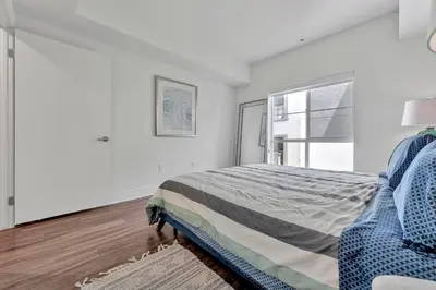 a white bedroom with a bed and a window at 7 Large Down Town Santa Monica Apartment in Los Angeles