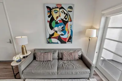 a living room with a couch and a painting on the wall at 7 Large Down Town Santa Monica Apartment in Los Angeles