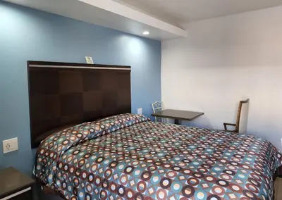 a bedroom with a bed in a blue room at DAY N NIGHT INN - Near Universal Studios Hollywood in Los Angeles
