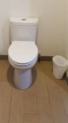 a white toilet in a bathroom with a wooden floor at DAY N NIGHT INN - Near Universal Studios Hollywood in Los Angeles