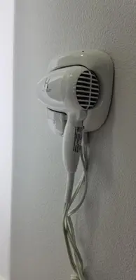 a white hairdryer hanging on a wall at DAY N NIGHT INN - Near Universal Studios Hollywood in Los Angeles