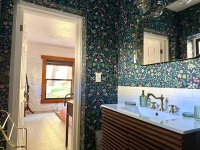 a bathroom with a sink and a mirror at Huttopia Paradise Springs in Valyermo