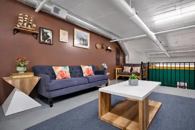 a living room with a couch and a table at St. Vincent Lofts in Los Angeles