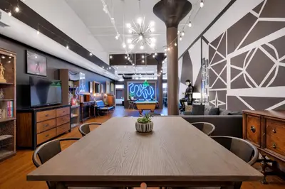 a dining room with a table and a tv at St. Vincent Lofts in Los Angeles