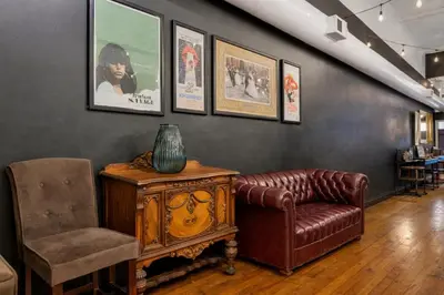 a living room with a leather couch and a chair at St. Vincent Lofts in Los Angeles