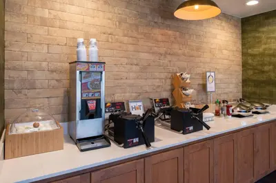 a counter with a soda machine on top of it at Fairfield Inn and Suites by Marriott Bakersfield Central in Bakersfield