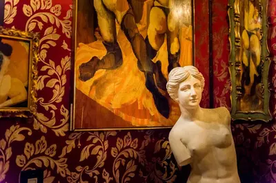a statue of a man in front of a painting at The Rosemary in Los Angeles