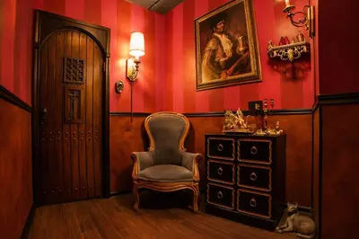 a hallway with a chair and a dresser and a painting at The Rosemary in Los Angeles