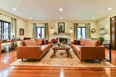 a living room with two leather couches and a fireplace at Beautiful airy architect-designed room and brand new private luxe bathroom in Los Angeles