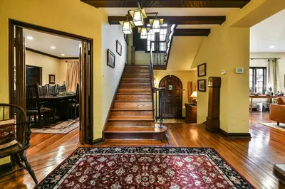 a living room with a staircase with a rug at Beautiful airy architect-designed room and brand new private luxe bathroom in Los Angeles