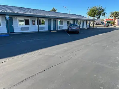 an empty parking lot in front of a building at La Casa Motel, Garden Grove - Anaheim in Garden Grove