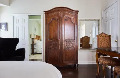 a bedroom with a large wooden door and a bed at Hollywood Hills Homestay in Los Angeles