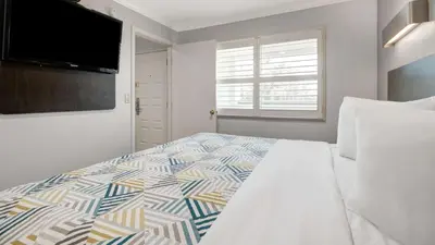 a bedroom with a bed and a flat screen tv at Studio 6 Ontario CA Convention Center Airport in Ontario