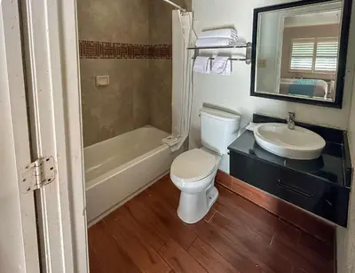 a bathroom with a white toilet and a sink at Studio 6 Ontario CA Convention Center Airport in Ontario