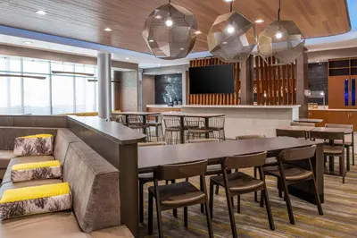 a dining room with a large table and chairs at SpringHill Suites by Marriott Riverside Redlands in Redlands
