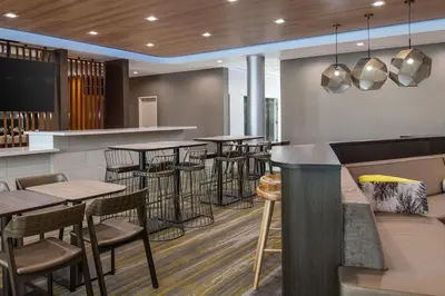 a bar in a restaurant with tables and stools at SpringHill Suites by Marriott Riverside Redlands in Redlands