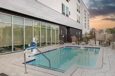 a swimming pool in front of a building at SpringHill Suites by Marriott Riverside Redlands in Redlands