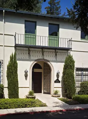 a white house with a balcony on top of it at The Langham Huntington, Pasadena in Pasadena
