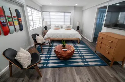 a bedroom with a bed and a table and chairs at 50 M to Sand LGB 2 King Suites in Long Beach