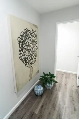a room with a painting on the wall and a plant at 50 M to Sand LGB 2 King Suites in Long Beach
