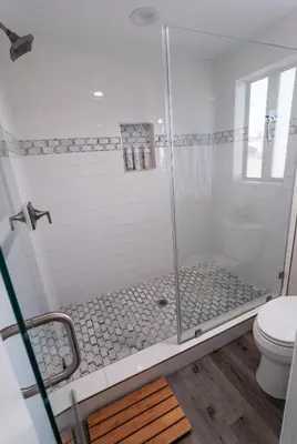 a bathroom with a glass shower with a toilet at 50 M to Sand LGB 2 King Suites in Long Beach