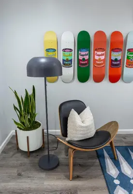 a hat sitting on a chair next to a skateboard at 50 M to Sand LGB 2 King Suites in Long Beach