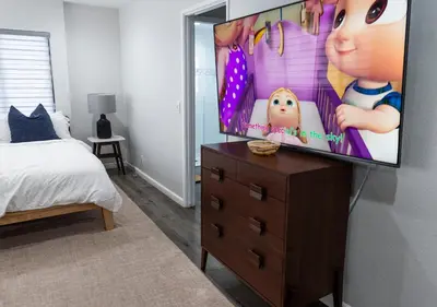 a bedroom with a flat screen tv on a dresser at 50 M to Sand LGB 2 King Suites in Long Beach
