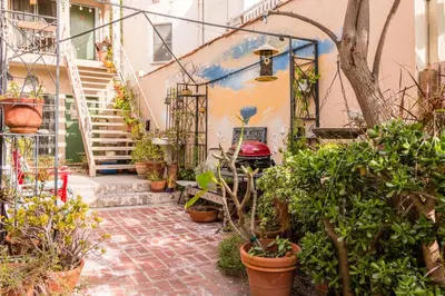 a courtyard with potted plants in front of a building at Sunny Boho Chic West Hollywood Flat! in Los Angeles