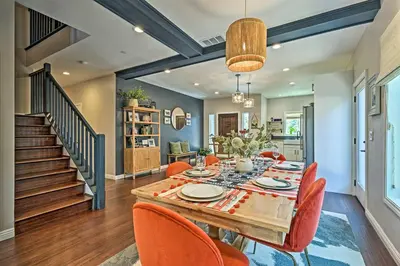a dining room with a table and orange chairs at Luxe Lake Arrowhead Farmhouse with Deck and Patio in Lake Arrowhead