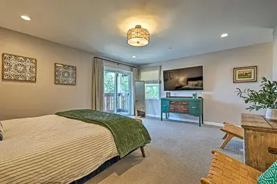 a bedroom with a bed and a desk and a television at Luxe Lake Arrowhead Farmhouse with Deck and Patio in Lake Arrowhead