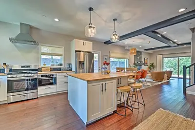 a large kitchen with white cabinets and a counter top at Luxe Lake Arrowhead Farmhouse with Deck and Patio in Lake Arrowhead