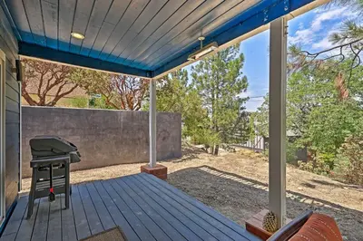 a patio with a grill on a wooden deck at Luxe Lake Arrowhead Farmhouse with Deck and Patio in Lake Arrowhead