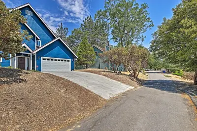 a blue house with a driveway in front of it at Luxe Lake Arrowhead Farmhouse with Deck and Patio in Lake Arrowhead