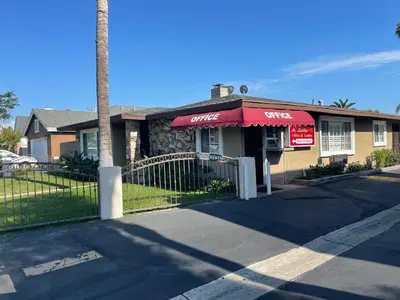 a store with a red awning on a building at Legacy inn & suites in Anaheim