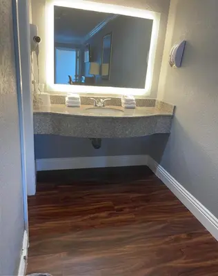 a bathroom with a sink and a mirror at Legacy inn & suites in Anaheim