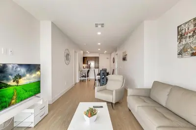 a living room with a couch and a table at Apart Hotel near Dodgers Stadium in Los Angeles