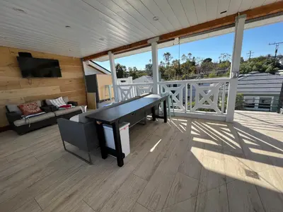 a living room with a ping pong table on a deck at Modern Bright New Studio with Roof-top Deck Walk to Santa Monica Beach, FreeWiFi, Parking in Santa Monica
