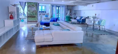 a living room with a white couch and a table at Huge Downtown LA Loft with Rooftop Pool & Jacuzzi in Los Angeles