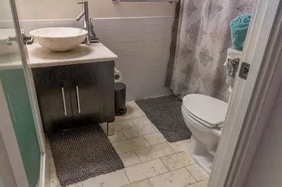 a bathroom with a sink and a toilet and a shower at Huge Downtown LA Loft with Rooftop Pool & Jacuzzi in Los Angeles