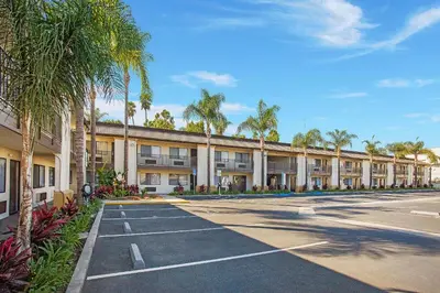 an empty parking lot in front of a building at Stanford Inn & Suites Anaheim in Anaheim