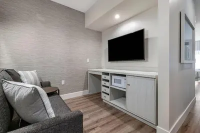 a living room with a tv on a wall at Cambria Hotel Calabasas - Malibu in Calabasas
